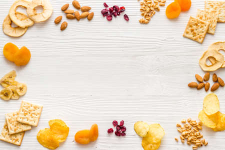 Snacks mix frame top view. Nuts and dried fruits with crackers, copy spaceの写真素材