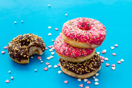 Colorful donuts close up, glazed and sprinkles bakery