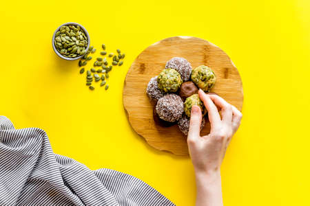 Vegen energy balls with pumpkin seeds and coconut, overhead viewの写真素材