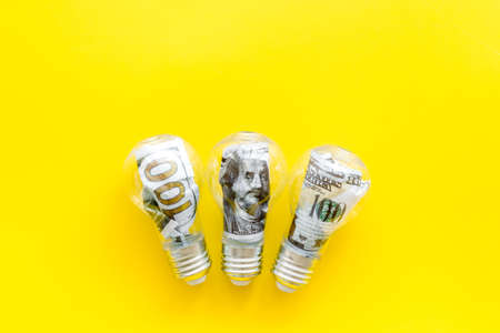 Money in light bulb - renewable eco energy conceptの写真素材