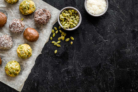 Top view of raw vegan energy balls with nuts and cacao