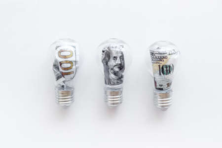 Money making idea concept with light bulb and dollar insideの写真素材