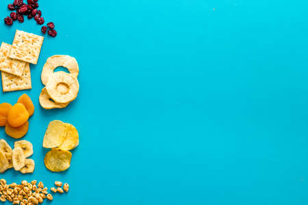 Flat lay of appetizers and snacks overhead. Nuts and dried fruits with crackers