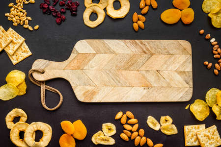Healthy snacks overhead - nuts and dried fruits with crackersの写真素材