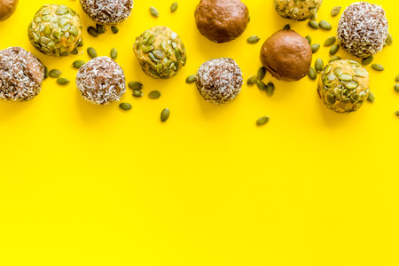 Raw energy balls with coconut and pumpkin seeds, top viewの写真素材