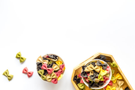 Top view of coloured farfalle pasta in bowlsの写真素材