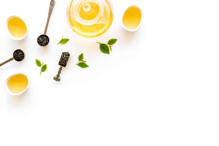 Teapot and cups with green tea, top view. Flat lay of tea ceremony concept.の写真素材