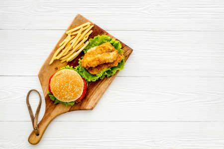 Delicious burgers with french fries and fried chicken. Flat lay, top viewの写真素材