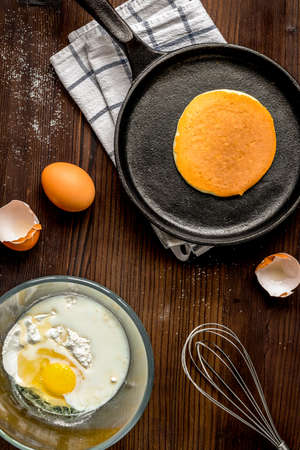 cooking pancake on wooden background top view ingredients for making