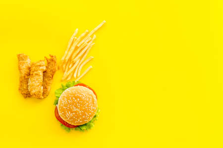 Fast food flat lay set. Burger with fried potatoes and chicken, top viewの写真素材