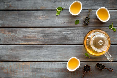 Tea ceremony concept. Hot and dry tea in teapot and cups, top viewの写真素材