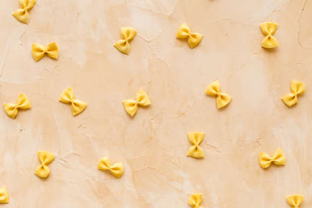 Pasta pattern - colored farfalle, top view. Italian food backgroundの写真素材