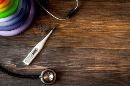 Child health care with stethoscope and thermometer in doctors office top view mock upの写真素材