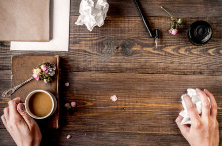 Writer workplace with tools on wooden background top view mock upの写真素材