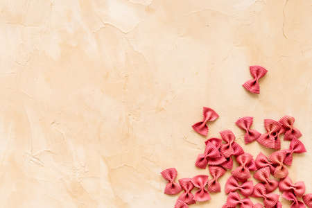 Heap of colored farfalle pasta, top view