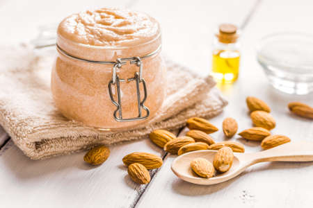 natural scrub with almond oil and sugar on light table backgroundの写真素材