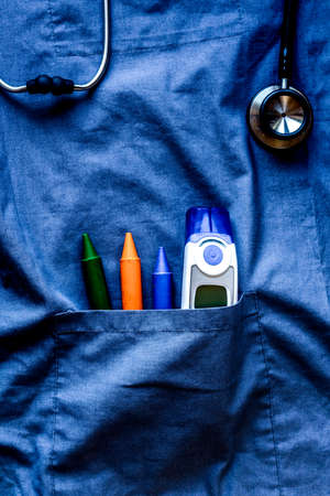 Pediatrician workplace with thermometer on blue background top view mockupの写真素材