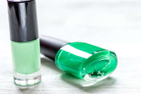 collection of nail polish on white desk background top view mock upの写真素材
