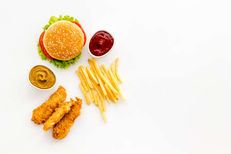 Fast food flat lay set. Burger with fried potatoes and chicken, top viewの写真素材