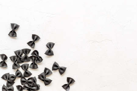 Heap of colored farfalle pasta, top view