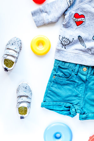 children flat lay with clothes white background top viewの写真素材