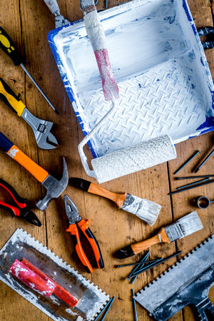 professional builder work with house renovation instruments on wooden background top view