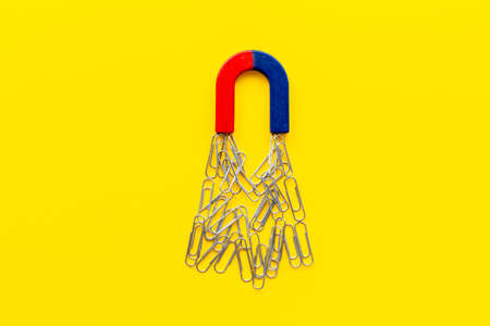 Horseshoe magnet collecting paper clips. Top viewの写真素材