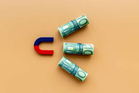 Finance and investment concept. Magnet collecting money