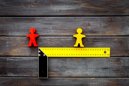 Keep social distance concept with two man figures and metal rulerの写真素材