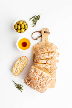 Sliced bread ciabatta with rosemary. Breakfast backgroundの写真素材