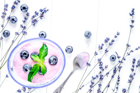lavender flowers with blueberry yoghurt mock up on white background top viewの写真素材