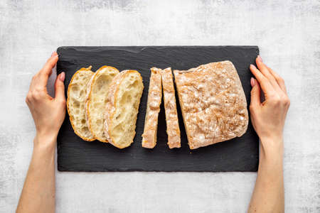 Freashly backed bread slice on cutting board, top view
