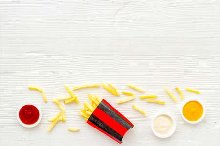 Patatoes french fries in red paper box with different saucesの写真素材