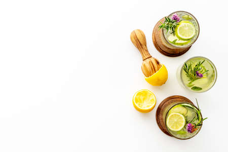 Cold fresh cocktail with summer herbs and lemon slicesの写真素材