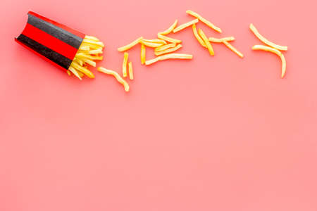 Fried potatoes french fries in red paper box. Fast food snack