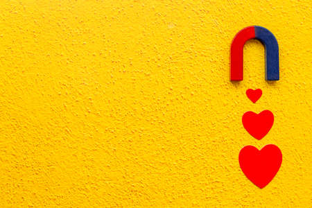 Dating love concept. Magnet with heart shapes, top view