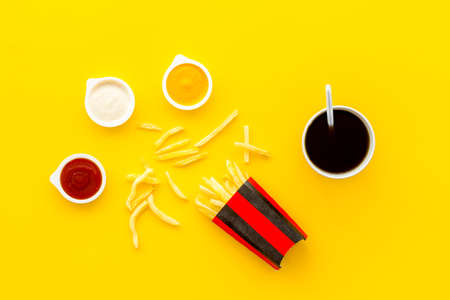 Patatoes french fries in red paper box with different saucesの写真素材