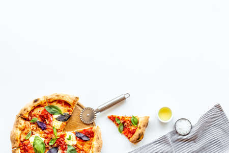 Sliced italian pizza margherita with tomatoes cheese and basil, top viewの写真素材