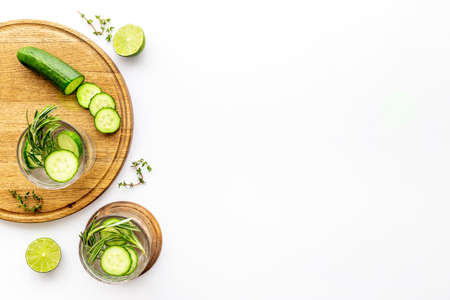 Cold fresh cocktail with lemon slices cucumber and rosemaryの写真素材