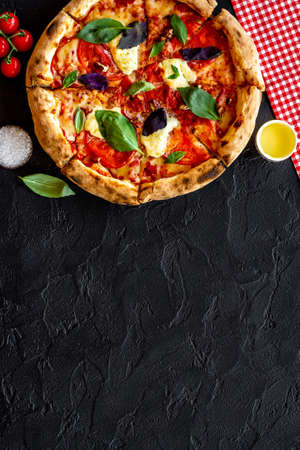 Margherita italian pizza with tomatoes cheese and basil, top viewの写真素材