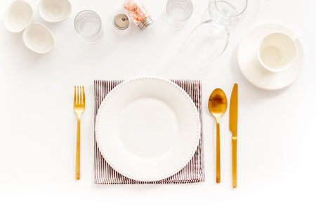 Eating utensil set - table setting for dinner with plate on napkinの写真素材