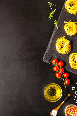 Flat lay of pasta ingredients with tomatoes olive oil spicesの写真素材