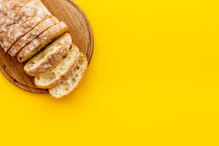 Freashly backed bread slice on cutting board, top view