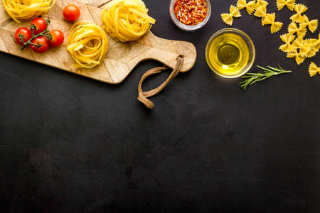 Flat lay of pasta ingredients with tomatoes olive oil spicesの写真素材