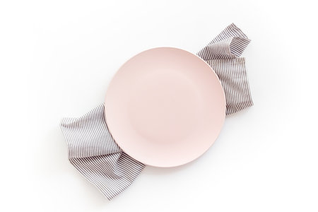 Table setting for dinner. Empty plate on napkin - dishware top viewの写真素材