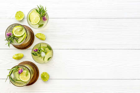 A lot of glasses of lemonade with summer herbs and lemon slicesの写真素材