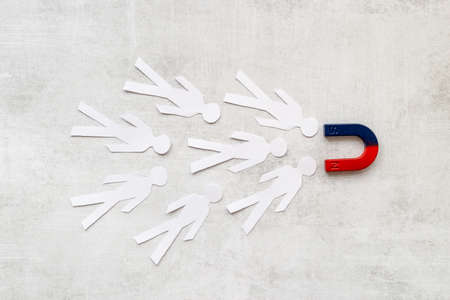 Horseshoe magnet pulls human figures. Increase team and recruiting concept