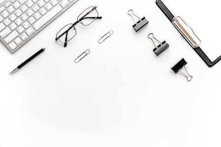 Trendy white office desk table with computer keyboard. Top view