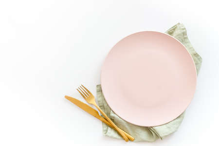 White plate with fork and knife on table napkin. Table settingの写真素材