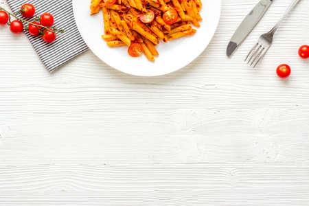 Cooked italian pasta in plate with tomato sauce and herbsの写真素材